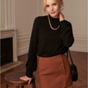 Sézane black mock neck sweater with button detail.